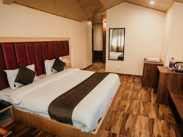 Room with wooden ceiling and maroon headboard